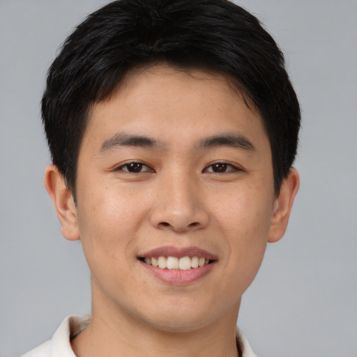 Joyful asian young-adult male with short  brown hair and brown eyes