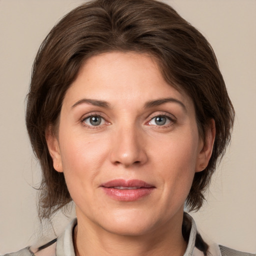 Joyful white adult female with medium  brown hair and grey eyes