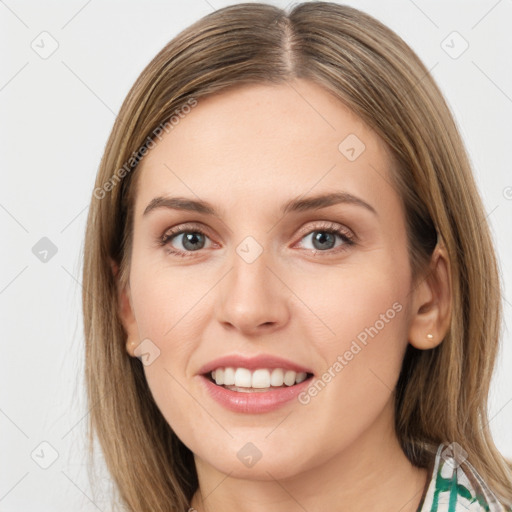 Joyful white young-adult female with long  brown hair and green eyes