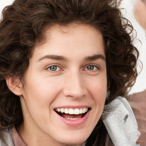 Joyful white young-adult female with medium  brown hair and green eyes