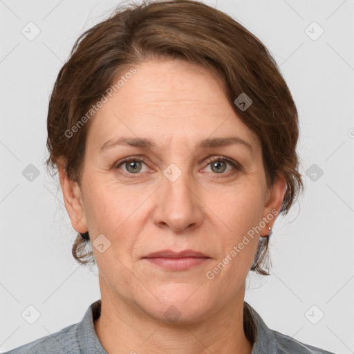 Joyful white adult female with medium  brown hair and grey eyes