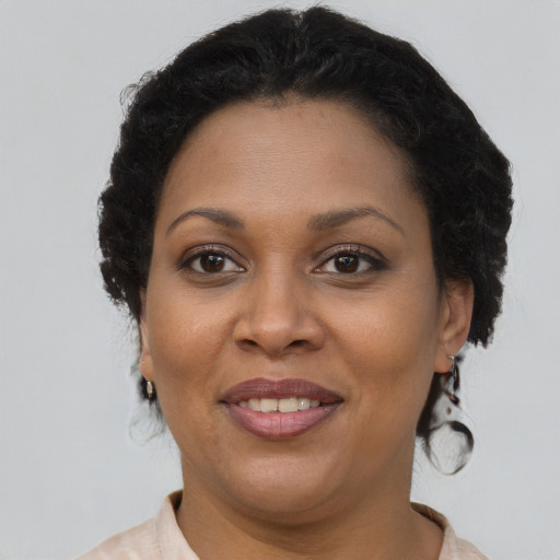 Joyful latino adult female with short  brown hair and brown eyes