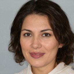 Joyful white adult female with medium  brown hair and brown eyes