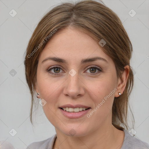 Joyful white young-adult female with medium  brown hair and grey eyes