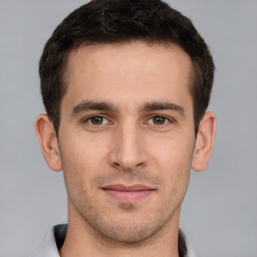 Joyful white young-adult male with short  brown hair and brown eyes