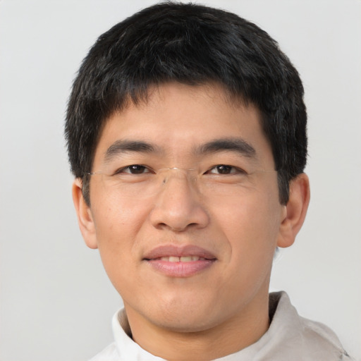 Joyful asian young-adult male with short  brown hair and brown eyes