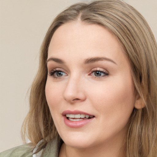 Joyful white young-adult female with long  brown hair and green eyes