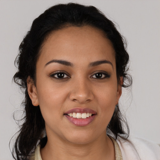 Joyful latino young-adult female with medium  brown hair and brown eyes