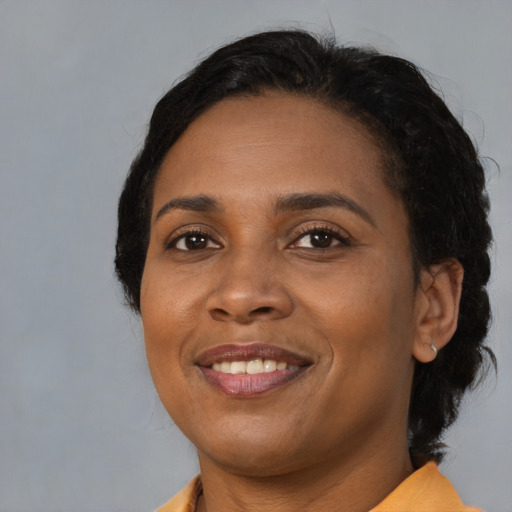Joyful black young-adult female with medium  black hair and brown eyes