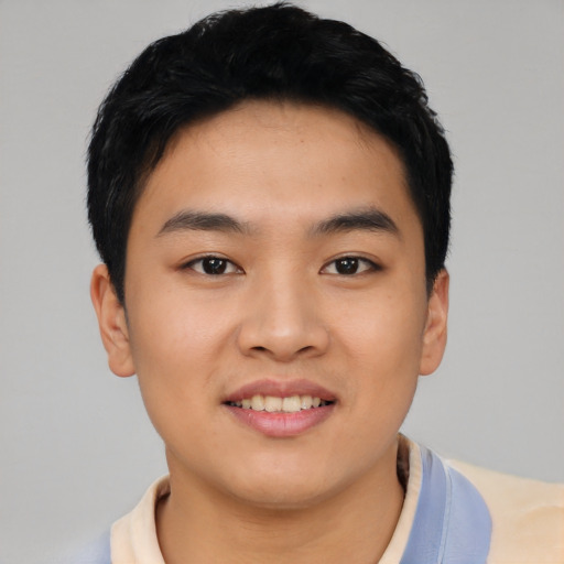 Joyful asian young-adult male with short  black hair and brown eyes