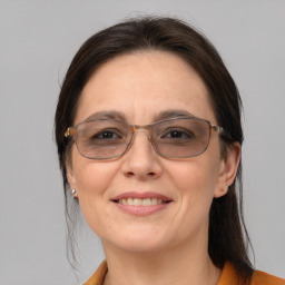 Joyful white adult female with medium  brown hair and brown eyes