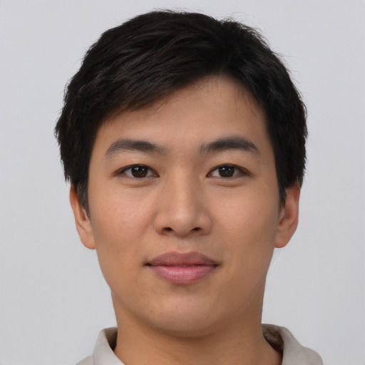 Joyful asian young-adult male with short  black hair and brown eyes