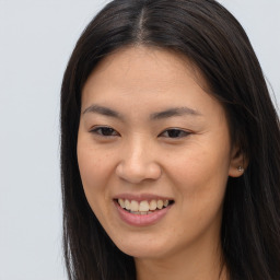 Joyful asian young-adult female with long  brown hair and brown eyes