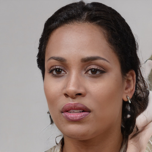 Joyful black young-adult female with medium  brown hair and brown eyes
