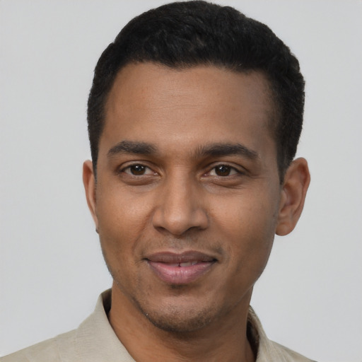 Joyful black young-adult male with short  black hair and brown eyes