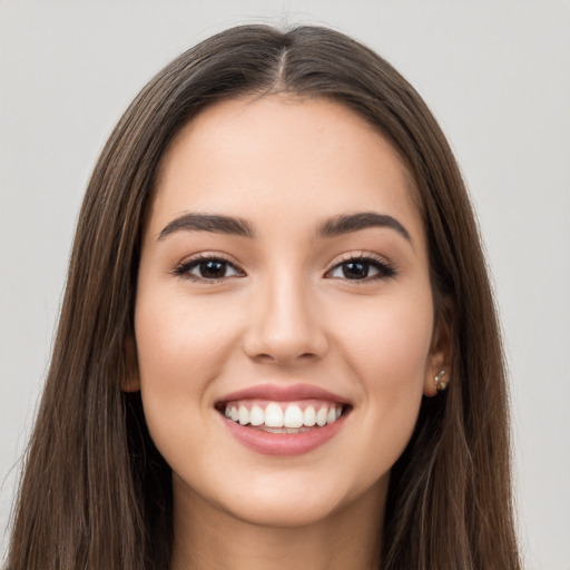 Joyful white young-adult female with long  brown hair and brown eyes