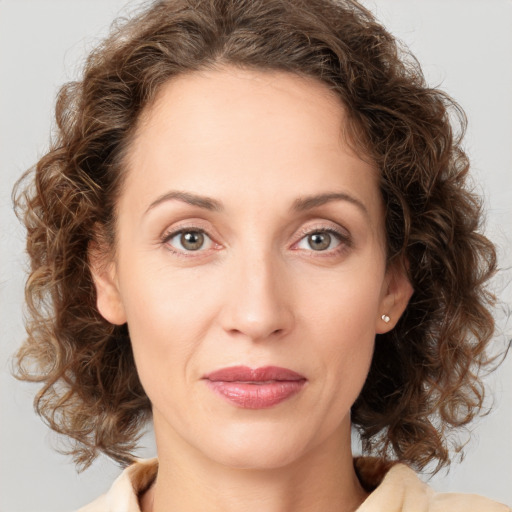 Joyful white young-adult female with medium  brown hair and green eyes