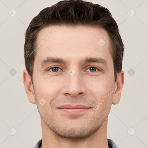 Joyful white young-adult male with short  brown hair and grey eyes