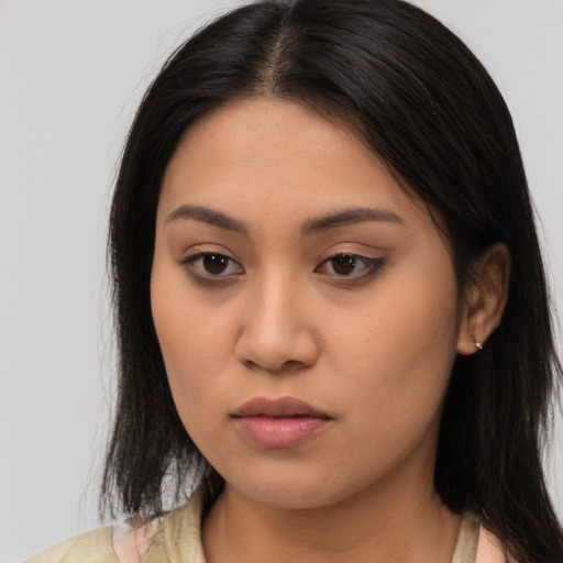 Neutral latino young-adult female with long  brown hair and brown eyes