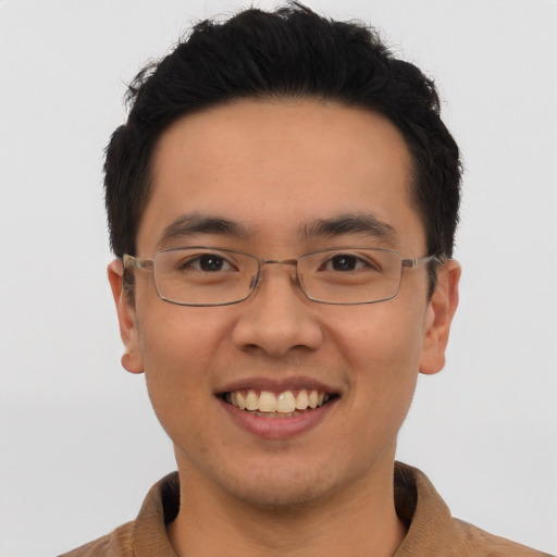 Joyful asian young-adult male with short  brown hair and brown eyes
