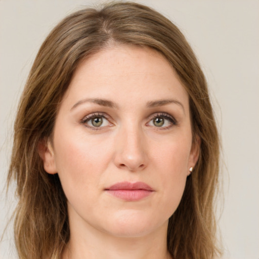 Joyful white young-adult female with long  brown hair and green eyes