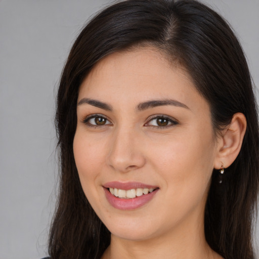 Joyful white young-adult female with long  brown hair and brown eyes