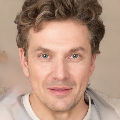 Joyful white adult male with short  brown hair and grey eyes