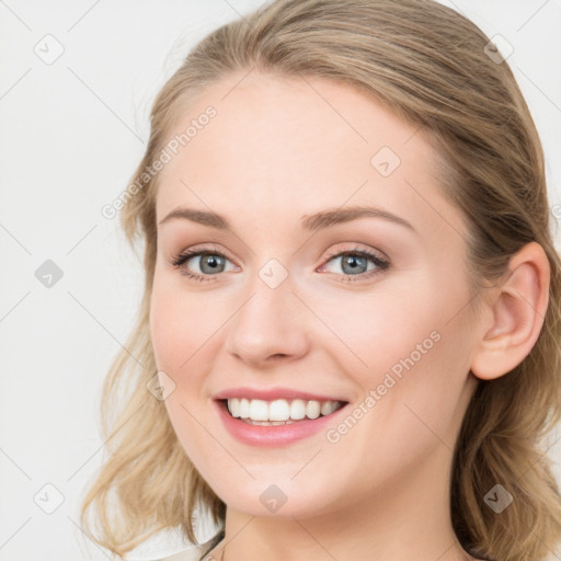 Joyful white young-adult female with long  brown hair and blue eyes