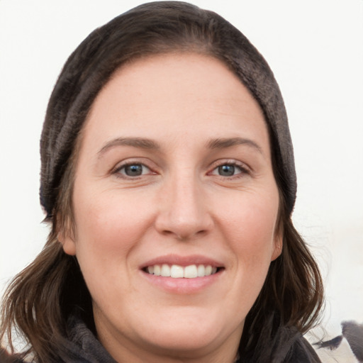 Joyful white young-adult female with long  brown hair and grey eyes