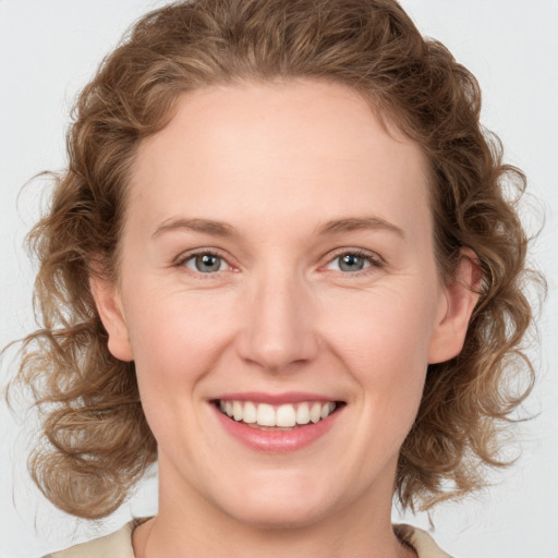 Joyful white young-adult female with medium  brown hair and green eyes