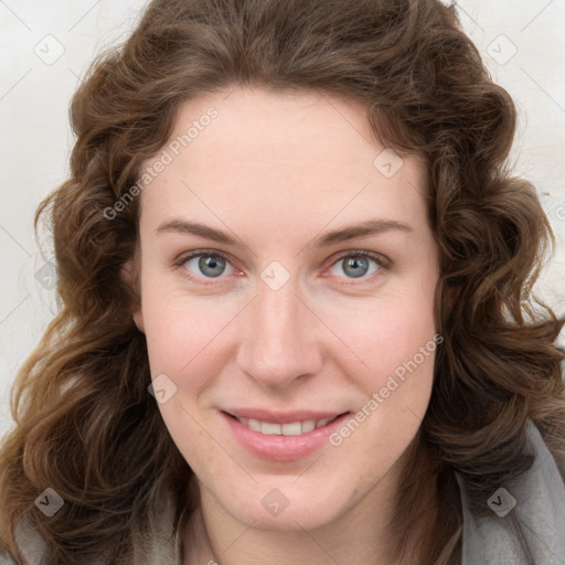 Joyful white young-adult female with long  brown hair and green eyes