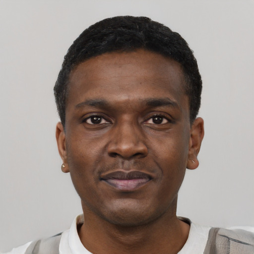 Joyful black young-adult male with short  black hair and brown eyes