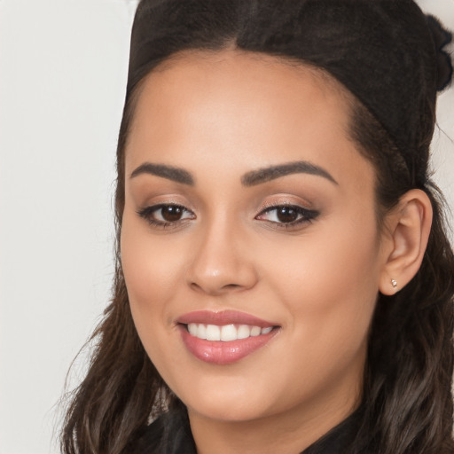 Joyful white young-adult female with long  black hair and brown eyes