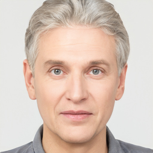 Joyful white adult male with short  brown hair and grey eyes