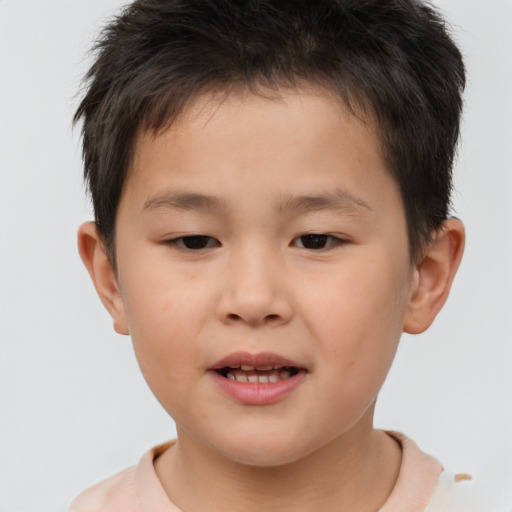 Joyful white child male with short  brown hair and brown eyes