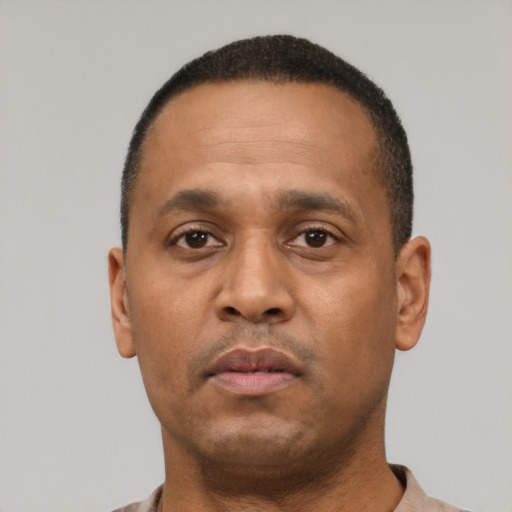 Neutral latino adult male with short  black hair and brown eyes