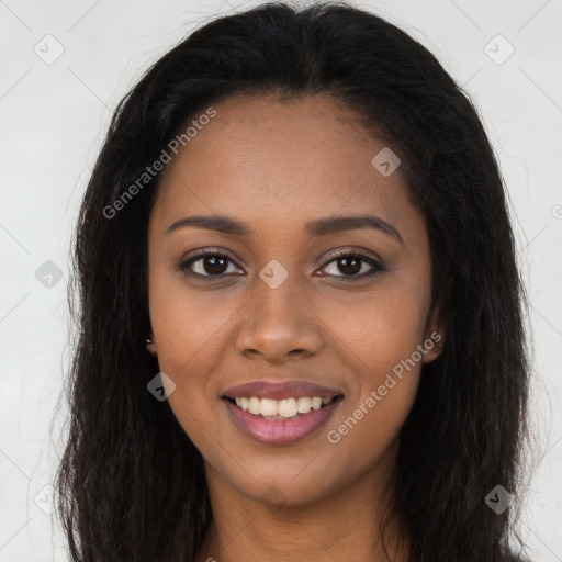 Joyful black young-adult female with long  brown hair and brown eyes