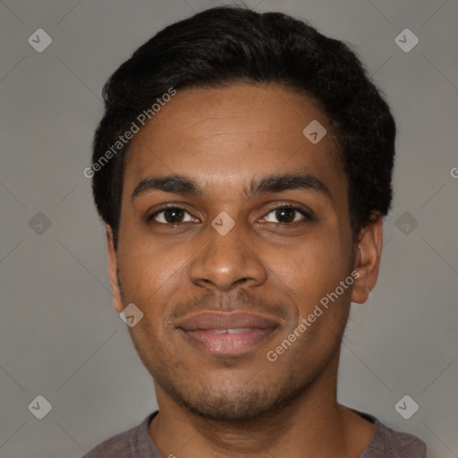 Joyful black young-adult male with short  black hair and brown eyes