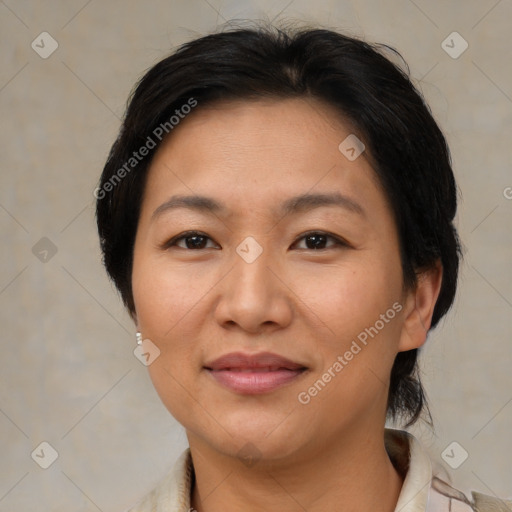 Joyful latino adult female with medium  brown hair and brown eyes