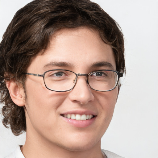 Joyful white young-adult male with short  brown hair and blue eyes