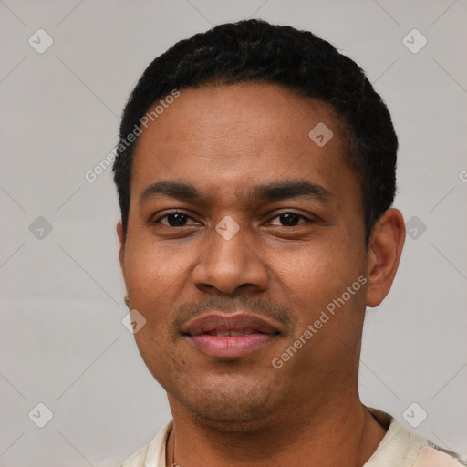 Joyful latino young-adult male with short  black hair and brown eyes