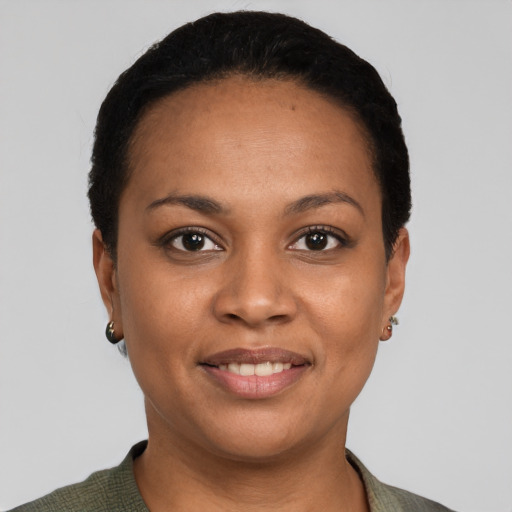 Joyful latino young-adult female with short  black hair and brown eyes