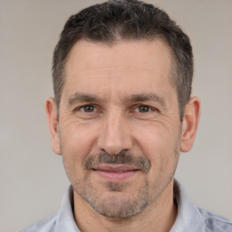 Joyful white adult male with short  brown hair and brown eyes