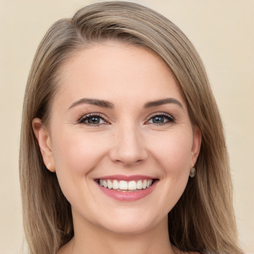 Joyful white young-adult female with long  brown hair and grey eyes