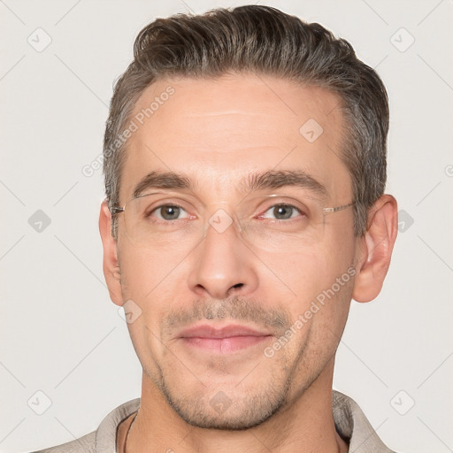 Joyful white adult male with short  brown hair and brown eyes