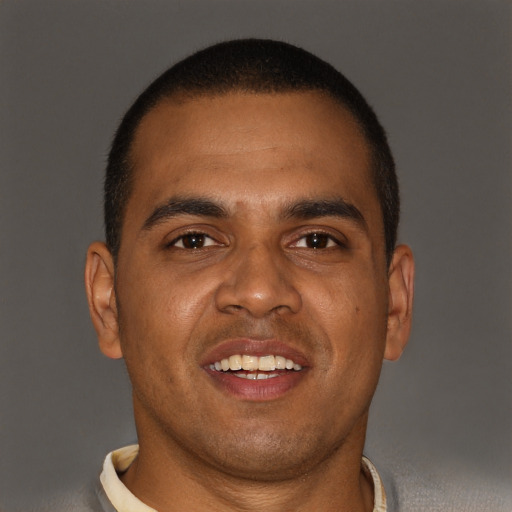 Joyful black young-adult male with short  brown hair and brown eyes