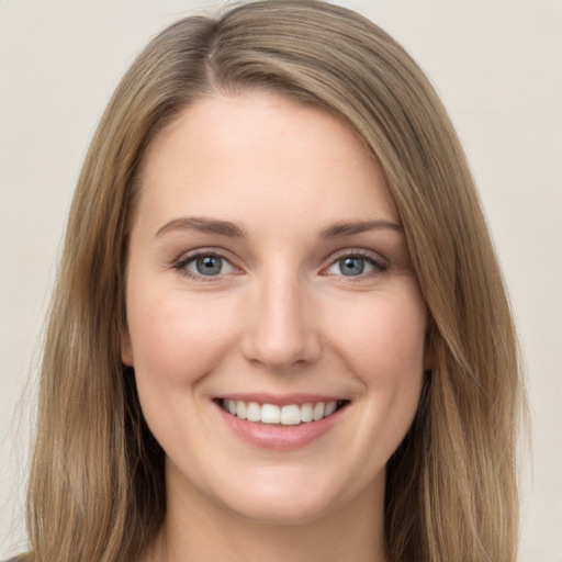 Joyful white young-adult female with long  brown hair and green eyes