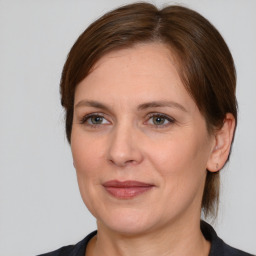 Joyful white adult female with medium  brown hair and brown eyes