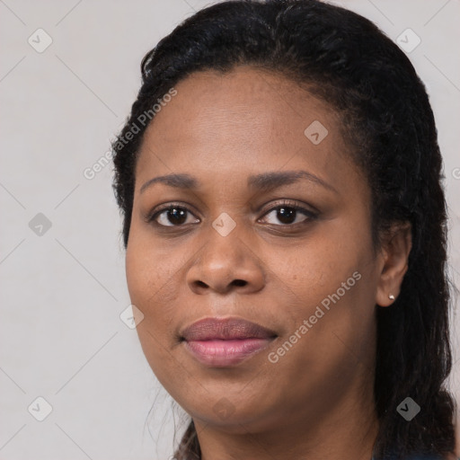 Joyful black young-adult female with long  black hair and brown eyes