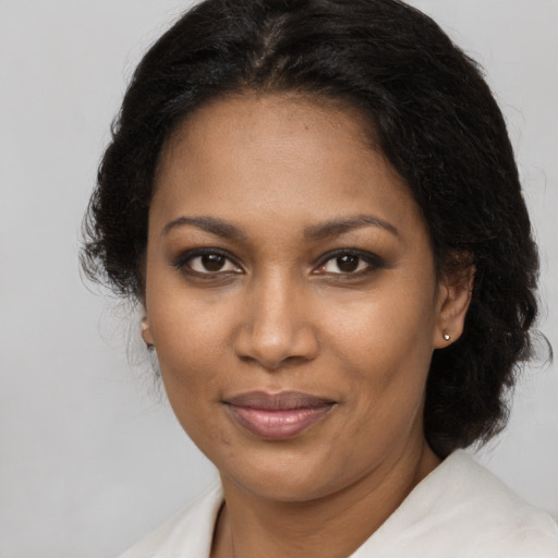 Joyful black young-adult female with medium  brown hair and brown eyes
